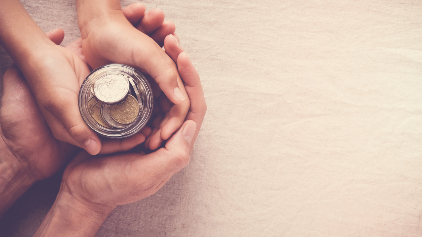 child and adult holding money jar, donation, saving concept